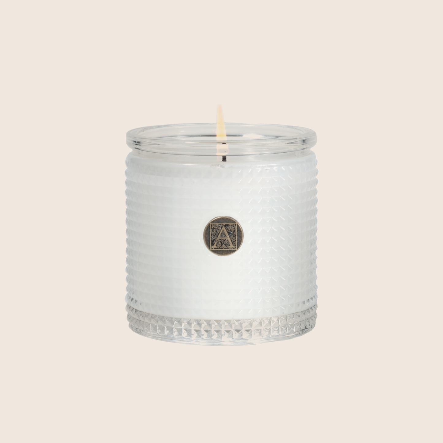 The White Teak & Moss Textured Glass Candle is the perfect everyday scent with a clean fragrance of fresh citrus over notes of earthy moss, coconut, and sandalwood. Our candles are all hand-poured in Arkansas. Made with a proprietary wax blend, ethically sourced containers and cotton wicks. Light one of these aromatic candles and transport yourself to a memory or emotion.